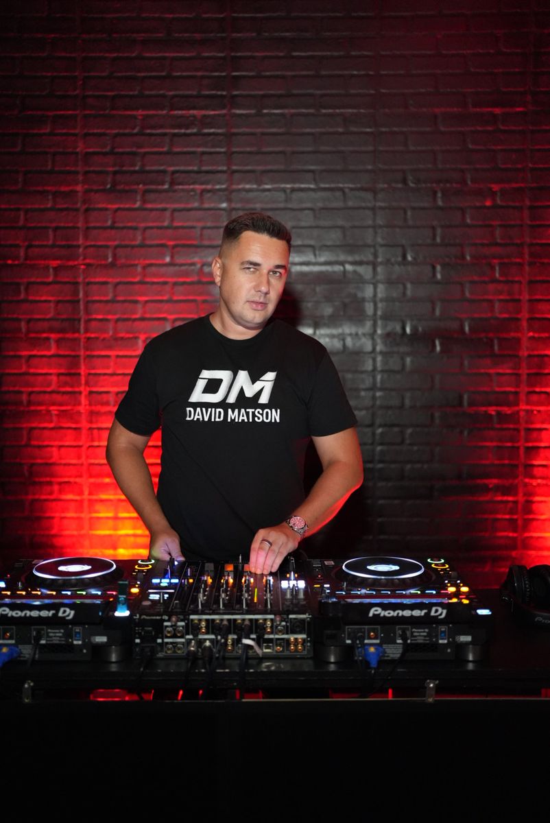 David Matson in DM tee behind Pioneer decks, red light